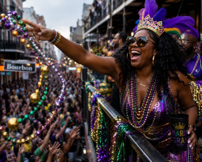 Throwing beads from a Bourbon Street balcony